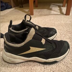 Black and gold Reebok size 12 sneakers, no laces.